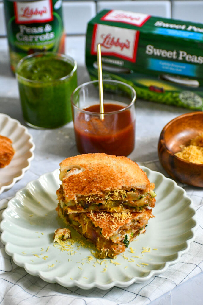 a spicy potato filling sandwiched between to pieces of bread, with sweet and savory chutneys and crunchy sev all toasted up. 