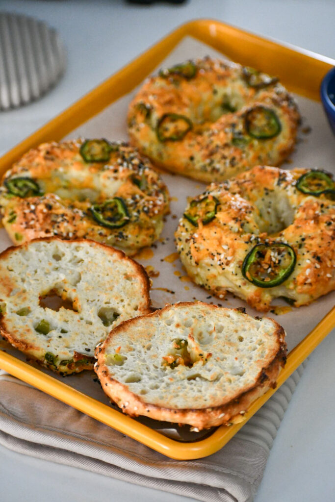 Freshly baked high-protein jalapeño cheddar bagels—golden brown, cheesy, and packed with flavor! Perfectly chewy with a hint of spice from diced jalapeños. A delicious, protein-packed breakfast or snack